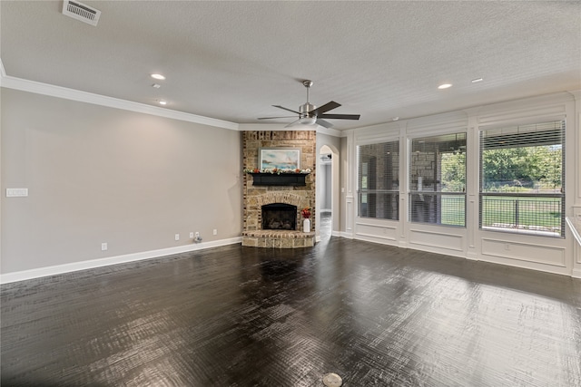 unfurnished living room featuring dark hardwood / wood-style flooring, ceiling fan, and a stone fireplace