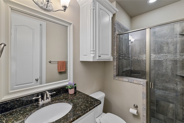 bathroom featuring walk in shower, vanity, and toilet