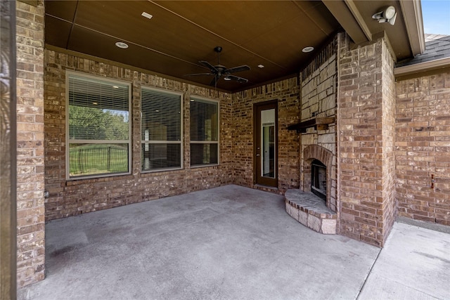 view of patio / terrace with an outdoor brick fireplace and ceiling fan