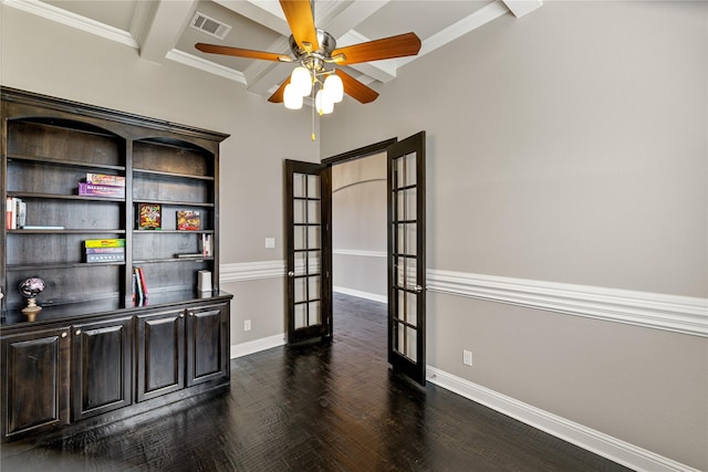 empty room with dark hardwood / wood-style floors, ornamental molding, ceiling fan, beam ceiling, and french doors