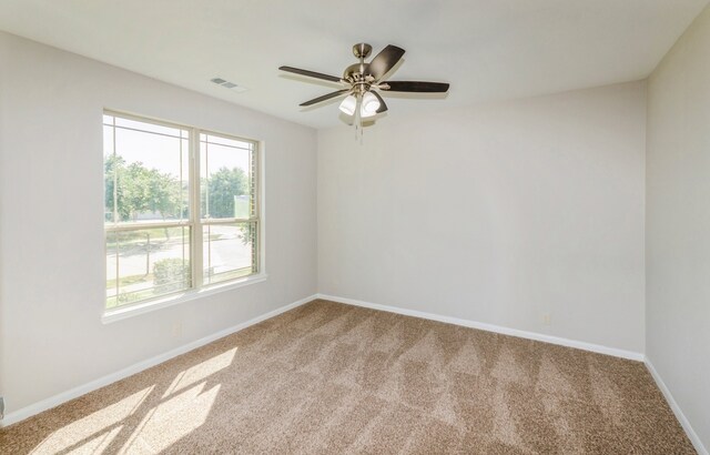 empty room with carpet flooring and ceiling fan