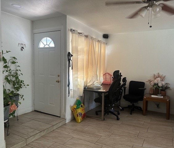 entrance foyer with a textured ceiling, light hardwood / wood-style flooring, and ceiling fan