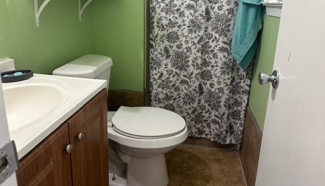 bathroom featuring vanity, toilet, curtained shower, and tile patterned flooring