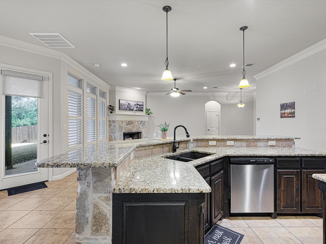 kitchen with decorative light fixtures, a fireplace, stainless steel dishwasher, sink, and ceiling fan