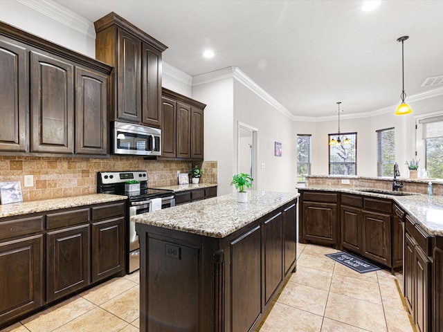 kitchen featuring dark brown cabinets, light tile patterned floors, a center island, stainless steel appliances, and sink