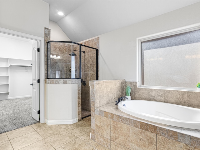 bathroom featuring vaulted ceiling, separate shower and tub, and tile patterned floors