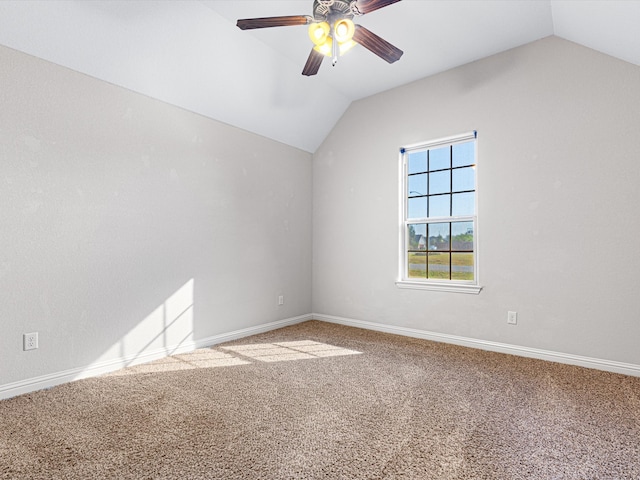 carpeted empty room with ceiling fan and vaulted ceiling