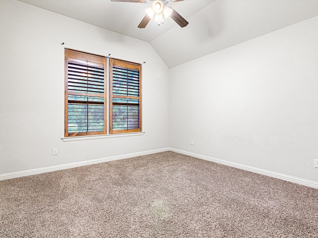 carpeted empty room featuring lofted ceiling and ceiling fan