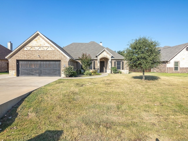 view of front facade with a front yard and a garage