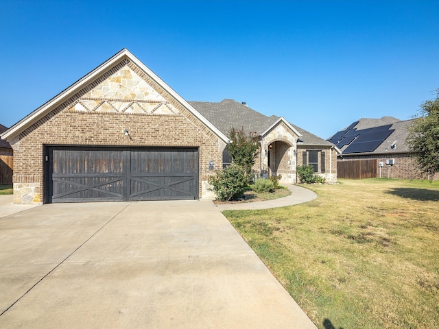 view of front facade featuring a front lawn and a garage