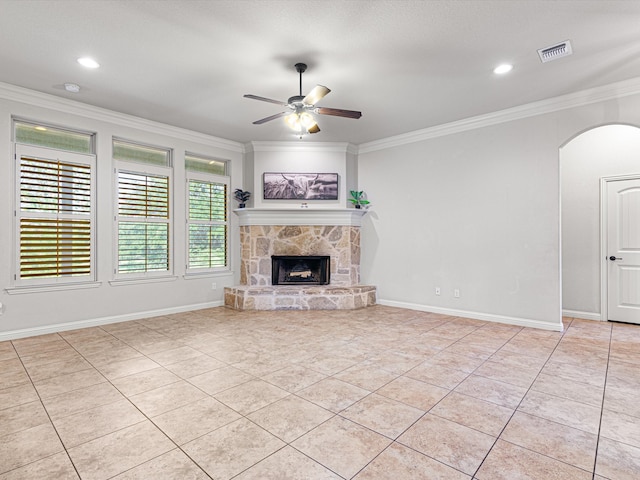 unfurnished living room with a fireplace, ornamental molding, and ceiling fan