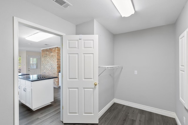 laundry area with washer hookup, dark hardwood / wood-style flooring, hookup for an electric dryer, and cabinets