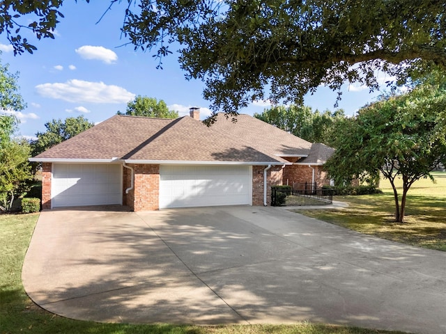 view of front of home with a garage and a front lawn