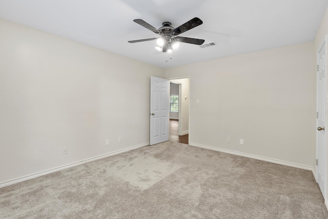 carpeted spare room featuring ceiling fan