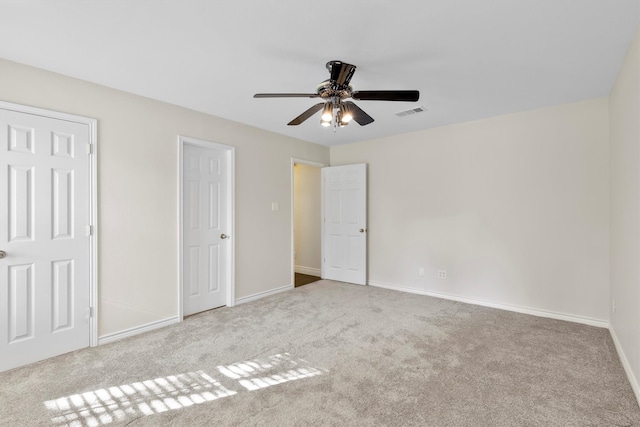 carpeted spare room with ceiling fan