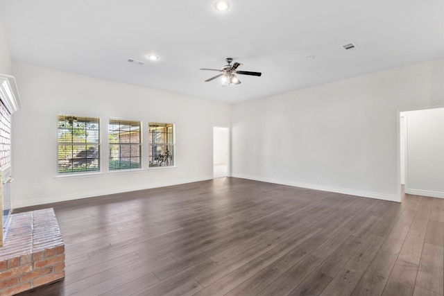 unfurnished living room with ceiling fan, dark hardwood / wood-style flooring, and a fireplace