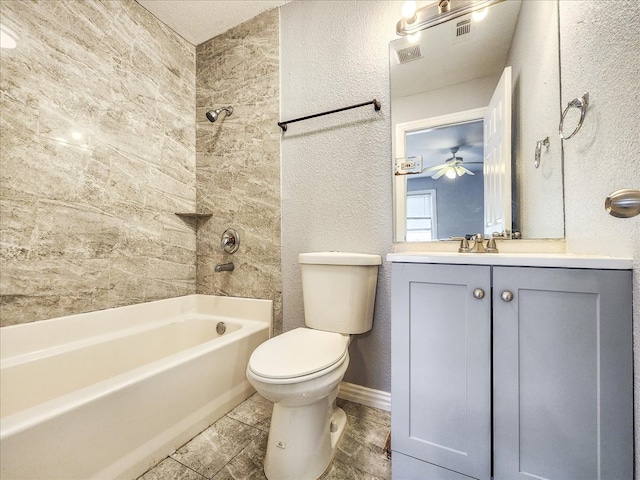 full bathroom featuring ceiling fan, toilet, tiled shower / bath combo, and vanity