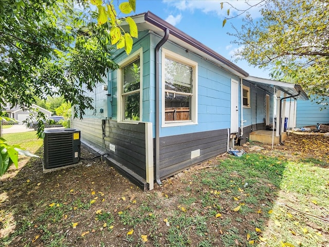 view of side of property featuring central AC