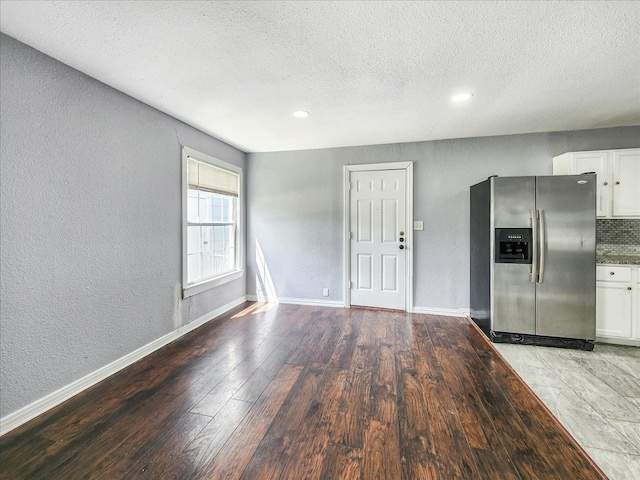 interior space with light wood-type flooring and a textured ceiling