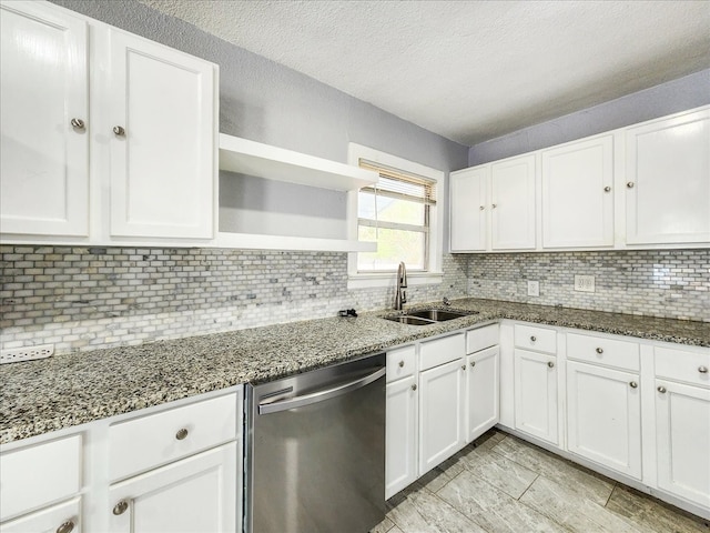 kitchen featuring backsplash, stone countertops, sink, white cabinetry, and stainless steel dishwasher