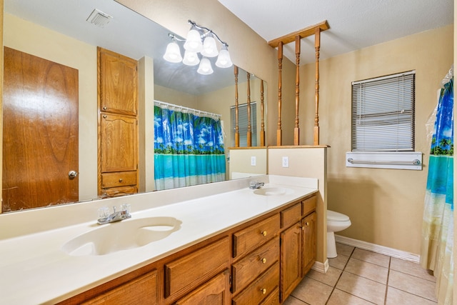 bathroom with vanity, toilet, and tile patterned floors