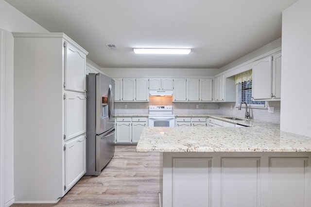 kitchen with light hardwood / wood-style floors, kitchen peninsula, white stove, sink, and stainless steel fridge with ice dispenser