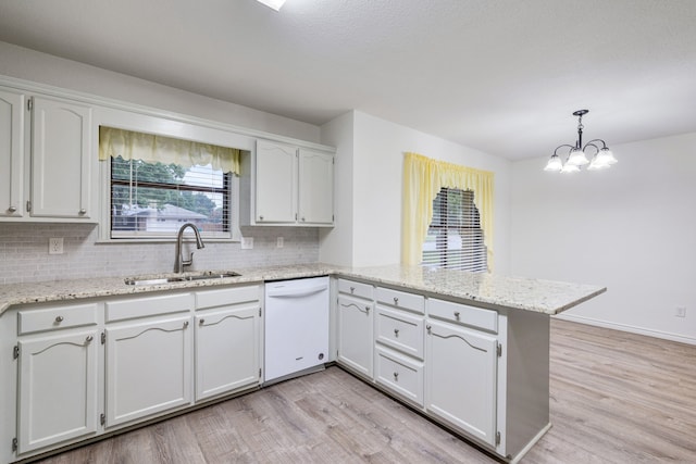 kitchen featuring pendant lighting, dishwasher, kitchen peninsula, and white cabinetry