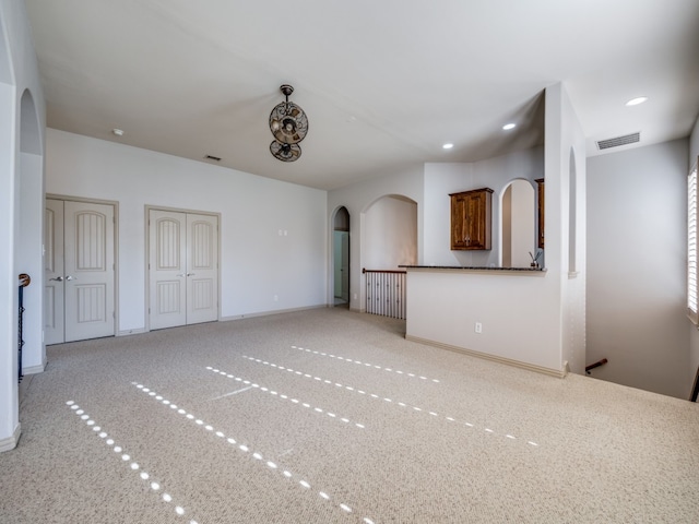 unfurnished living room featuring carpet