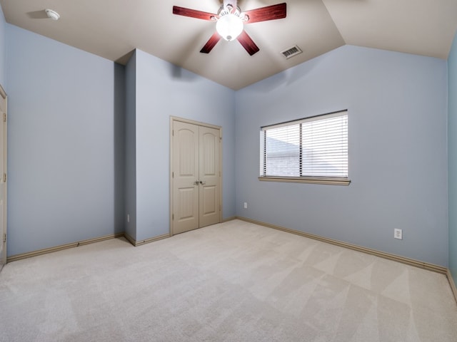 unfurnished bedroom with light colored carpet, ceiling fan, and lofted ceiling