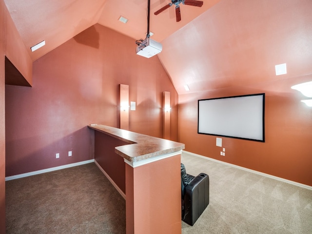 home theater featuring lofted ceiling, ceiling fan, and carpet floors