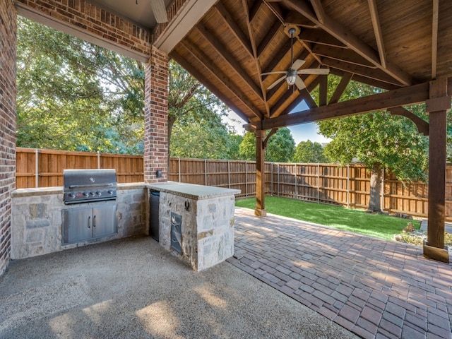 view of patio / terrace featuring area for grilling, ceiling fan, and a grill