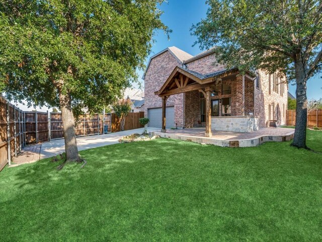 rear view of property featuring a lawn and a patio