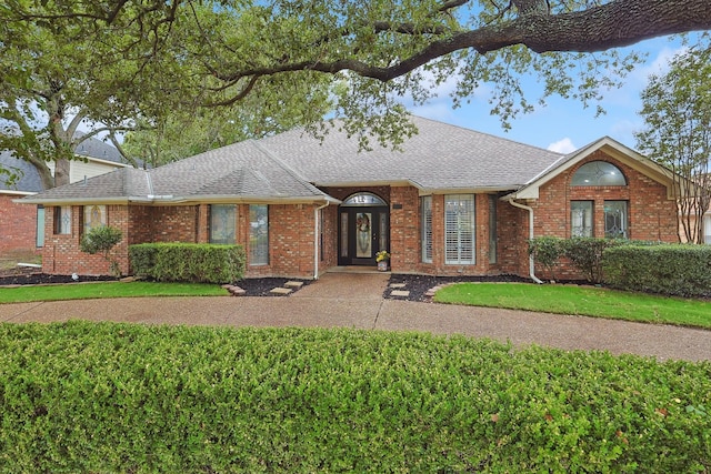 ranch-style house with a front lawn