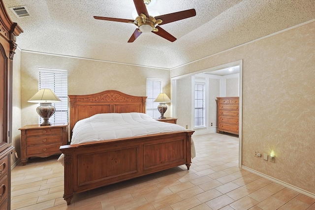 bedroom with light wood-type flooring, lofted ceiling, ceiling fan, and a textured ceiling