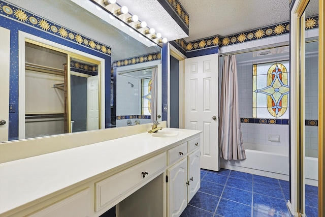 bathroom with a textured ceiling, vanity, shower / bath combo with shower curtain, and a healthy amount of sunlight