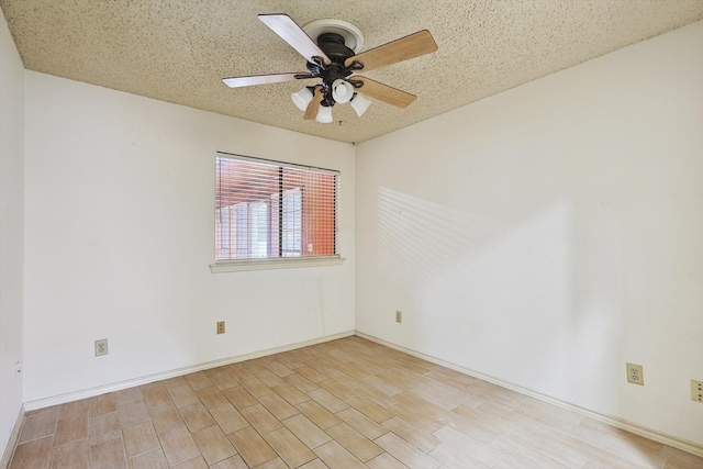 unfurnished room featuring ceiling fan, light hardwood / wood-style floors, and a textured ceiling