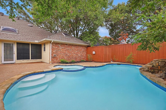 view of swimming pool featuring an in ground hot tub