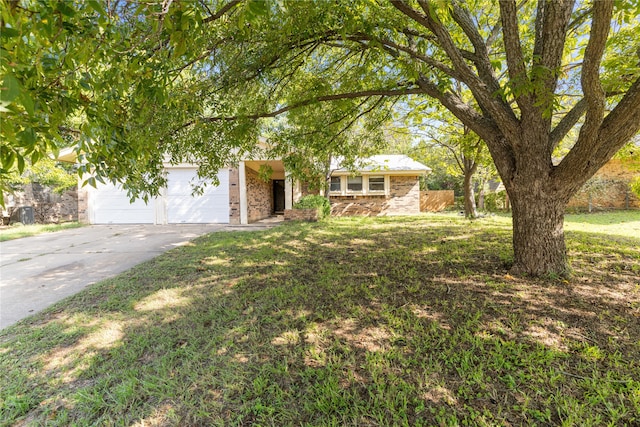 view of front of house featuring a front yard and a garage