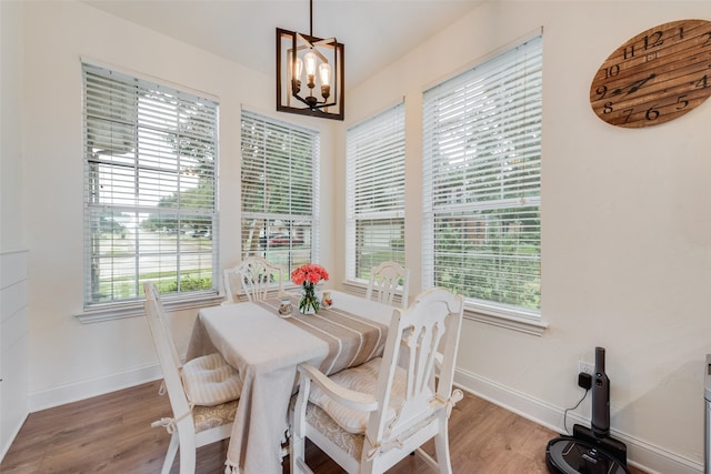 dining room featuring hardwood / wood-style flooring and a chandelier