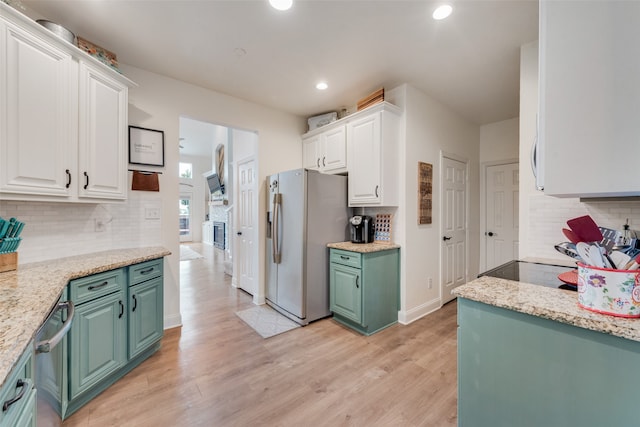 kitchen with green cabinetry, stainless steel appliances, light hardwood / wood-style floors, and white cabinetry