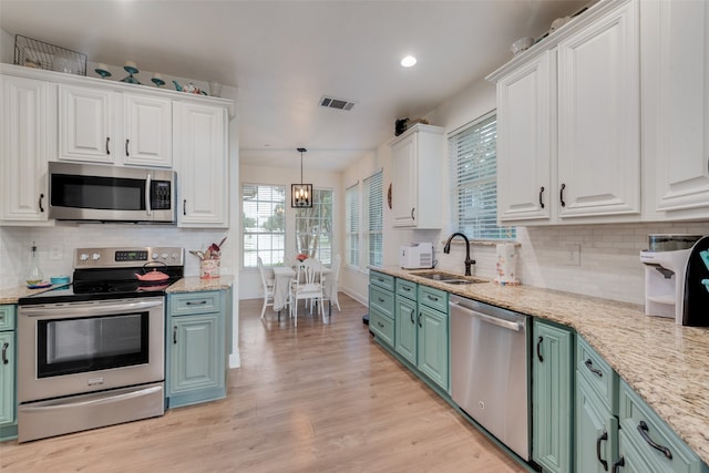 kitchen featuring white cabinets, green cabinetry, light hardwood / wood-style flooring, stainless steel appliances, and sink