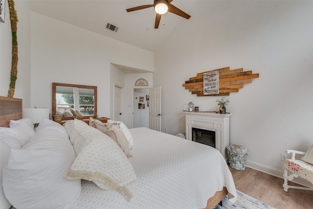 bedroom featuring high vaulted ceiling, ceiling fan, and light hardwood / wood-style floors