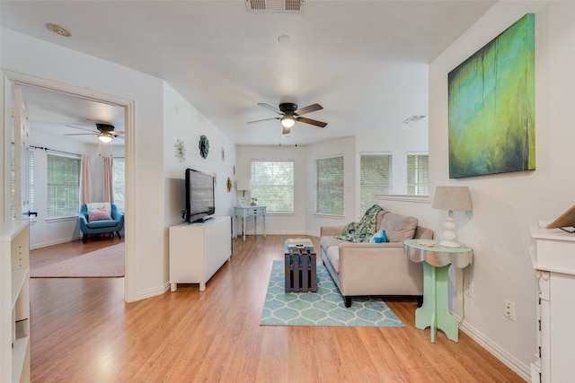 living room featuring ceiling fan and light hardwood / wood-style floors