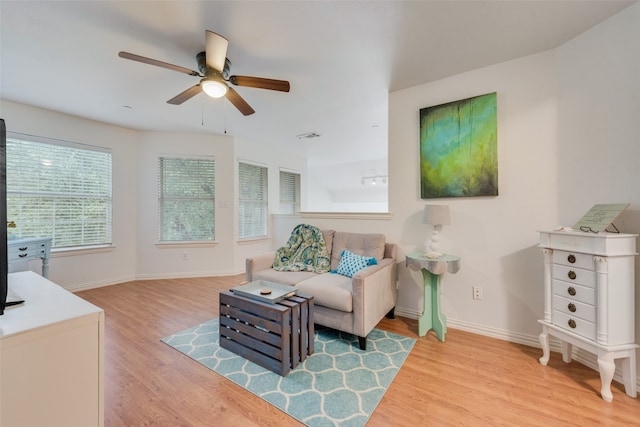 living room with ceiling fan and hardwood / wood-style flooring