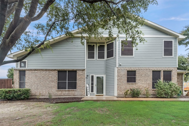 rear view of property with a lawn