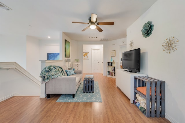 living room with ceiling fan and light hardwood / wood-style floors