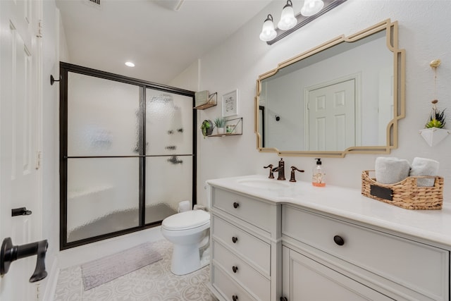 bathroom featuring tile patterned flooring, vanity, toilet, and an enclosed shower