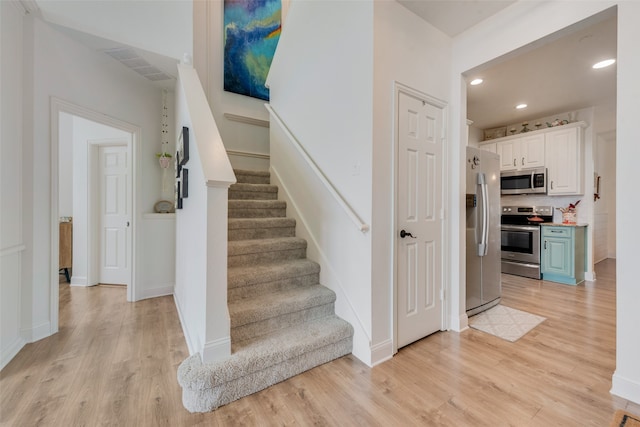 staircase with wood-type flooring