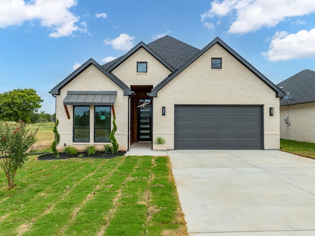 modern farmhouse style home with a garage, roof with shingles, concrete driveway, and a front yard