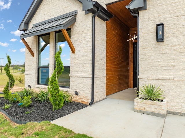 view of property exterior featuring metal roof and a standing seam roof